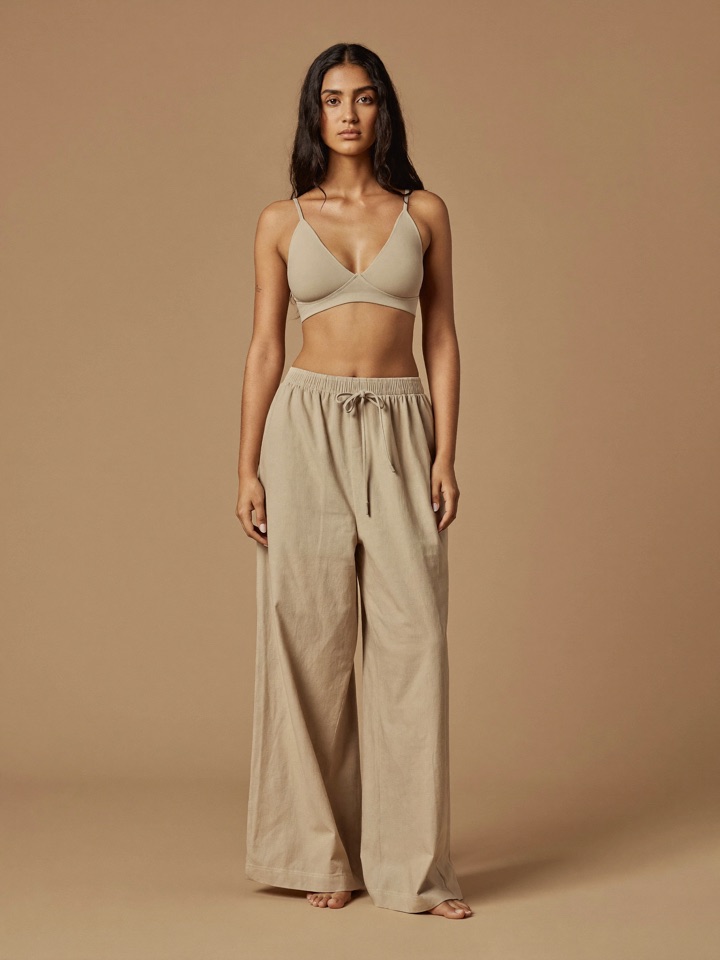 Elin Flare Trouser in Oat, front view, worn with a bone bra top.