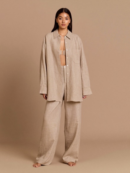 Noor Linen Shirt in Bone, worn open over oat wide trousers.