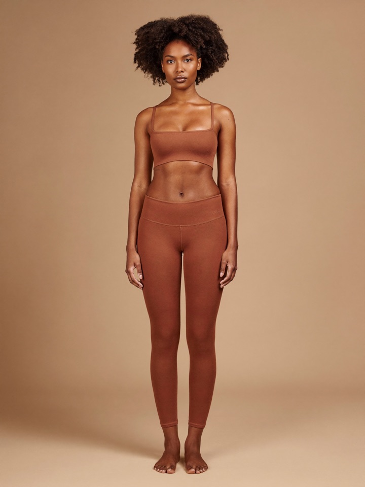Sona Ribbed Bra in Clay, front view, worn with matching leggings.